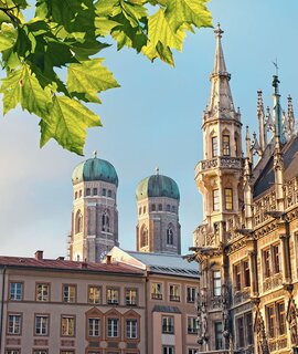 Muenchen Marienplatz | © Gettyimages.com/alexsl Untersicht auf den marienplatz mit Frauenkirche, Rathaus und Blaettern am oberen Rand des Bildes | © Gettyimages.com/alexsl